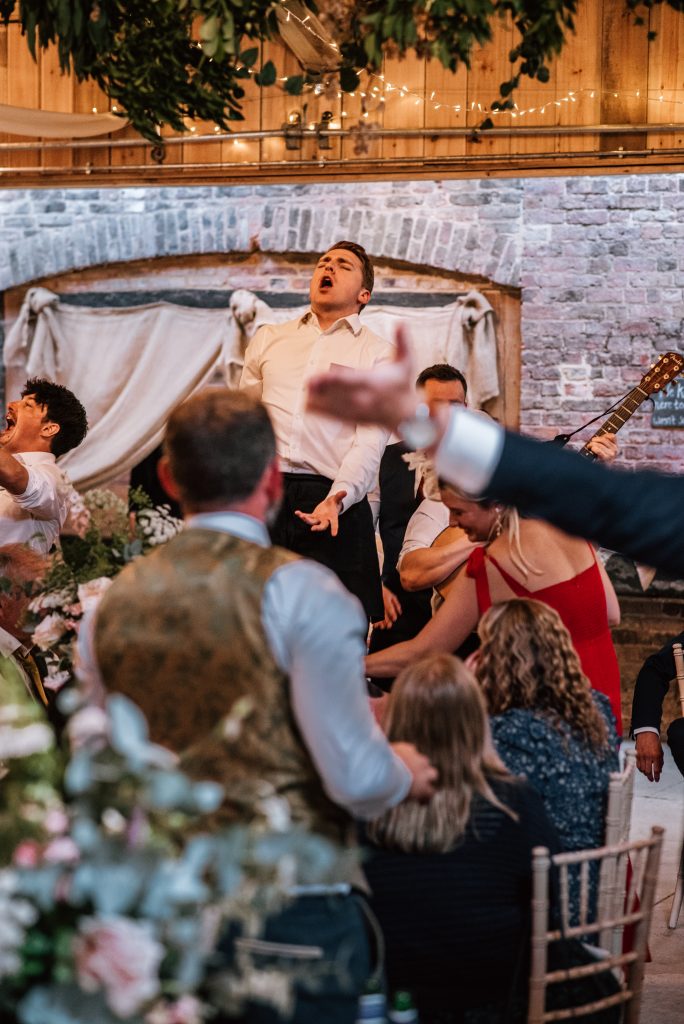 Singing waiters. cotswolds wedding photographer at Milton End Farm