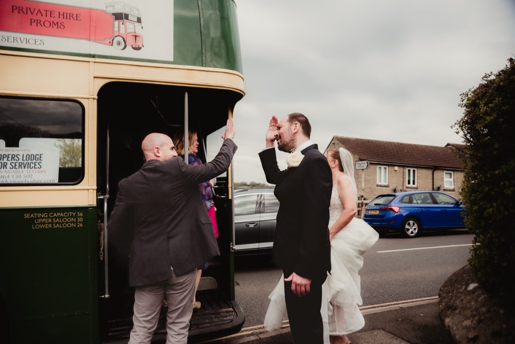 high fives at stroud registry office - candid wedding photographer