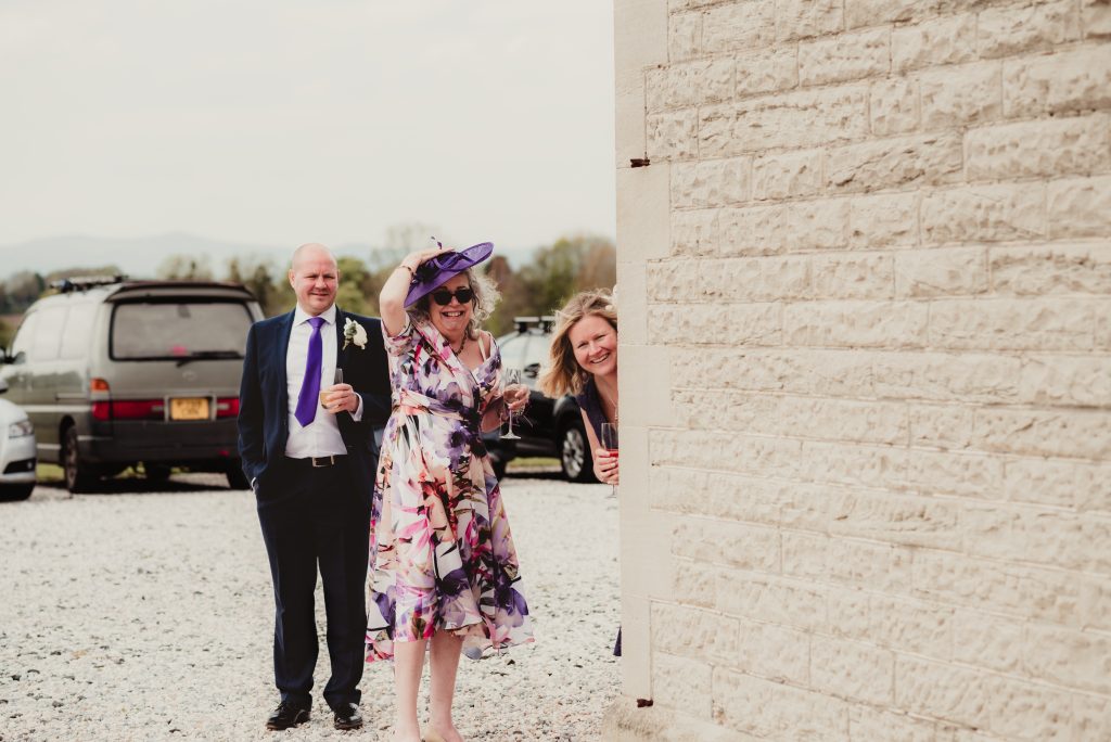 Guests peeking during photos – documentary wedding photography.
