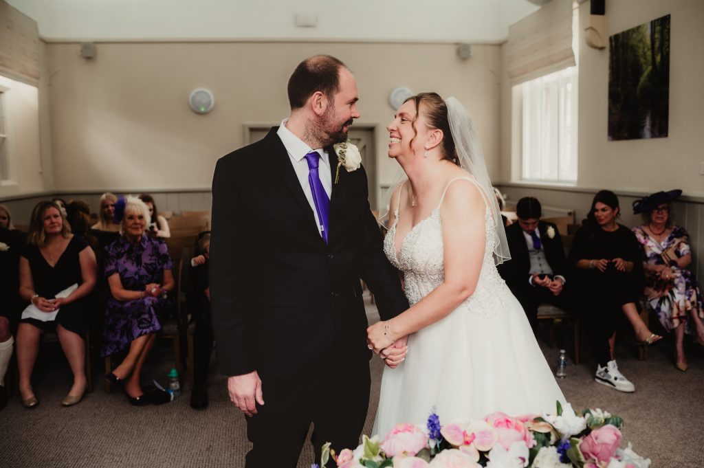 Couple holding hands during vows – emotional Stroud wedding ceremony