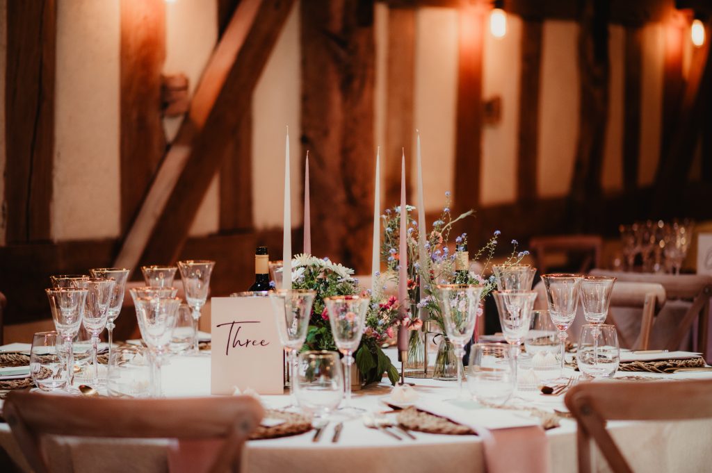 Beautifully styled wedding breakfast tables with rustic decor and personalised wedding stationery at Barns and Yard
