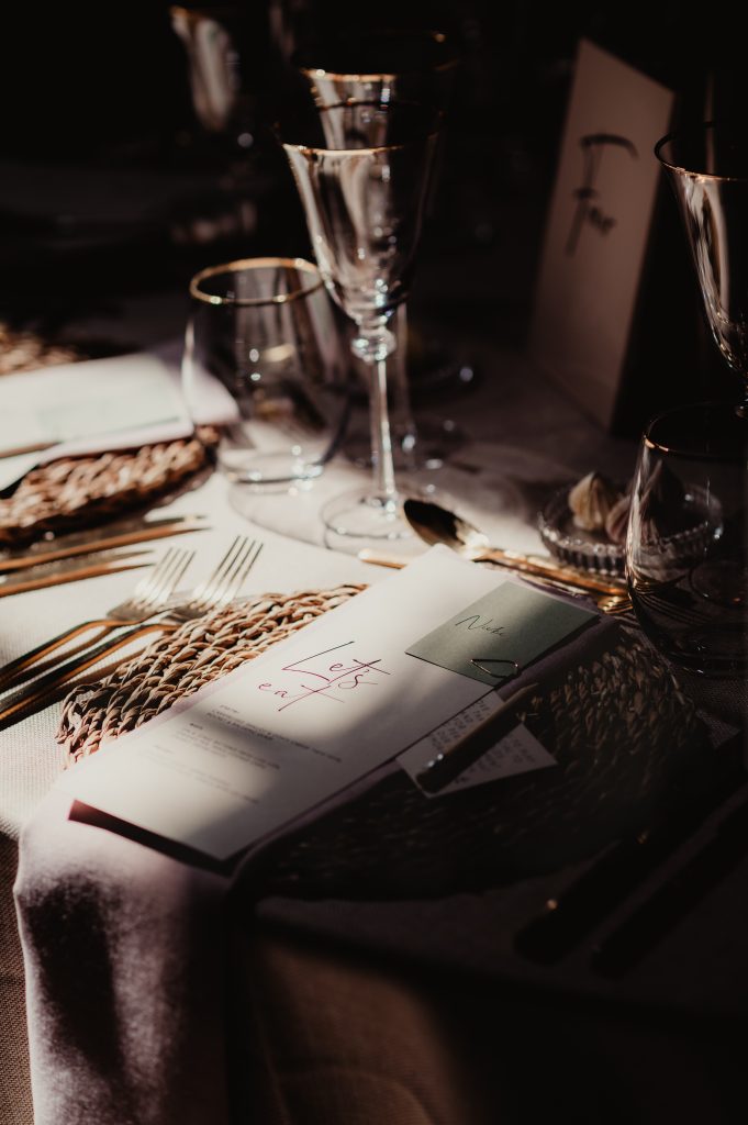 Rustic wedding table décor with floral arrangements and elegant stationery at Barns and Yard