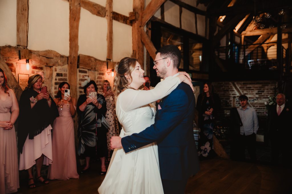 First dance inside the barn at Barns and Yard, with fairy lights and dancing guests all around