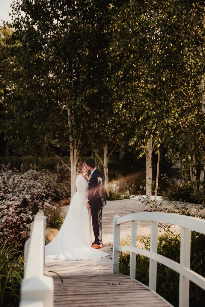 Evening portrait of the couple framed by the glow of sunset at Barns and Yard wedding venue
