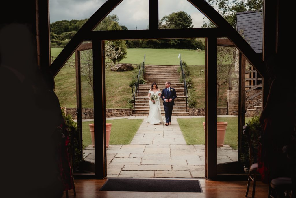 father and bride walking to the aisle at the barn at upcote