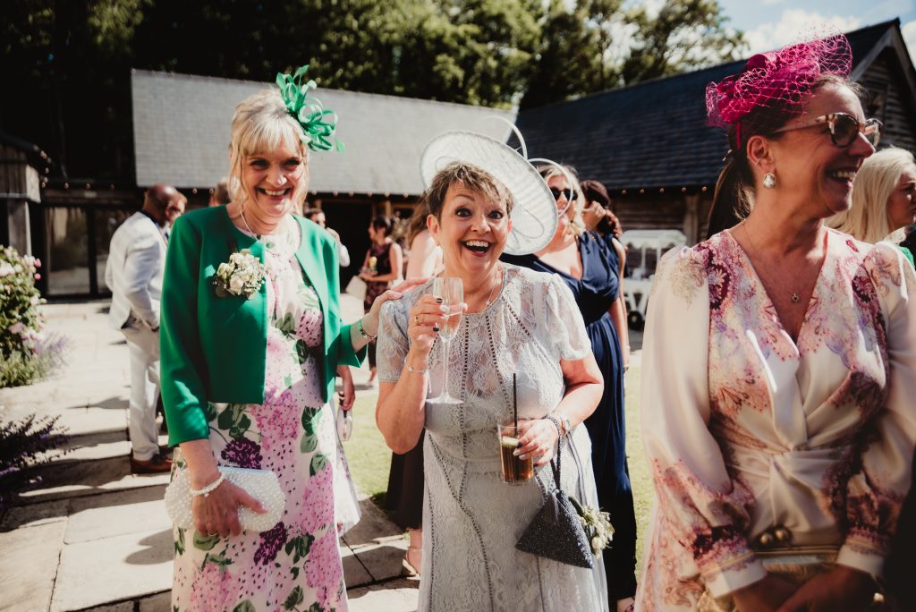 cocktails in the garden at The Barn at Upcote, candid shot by Cotswold wedding photographer