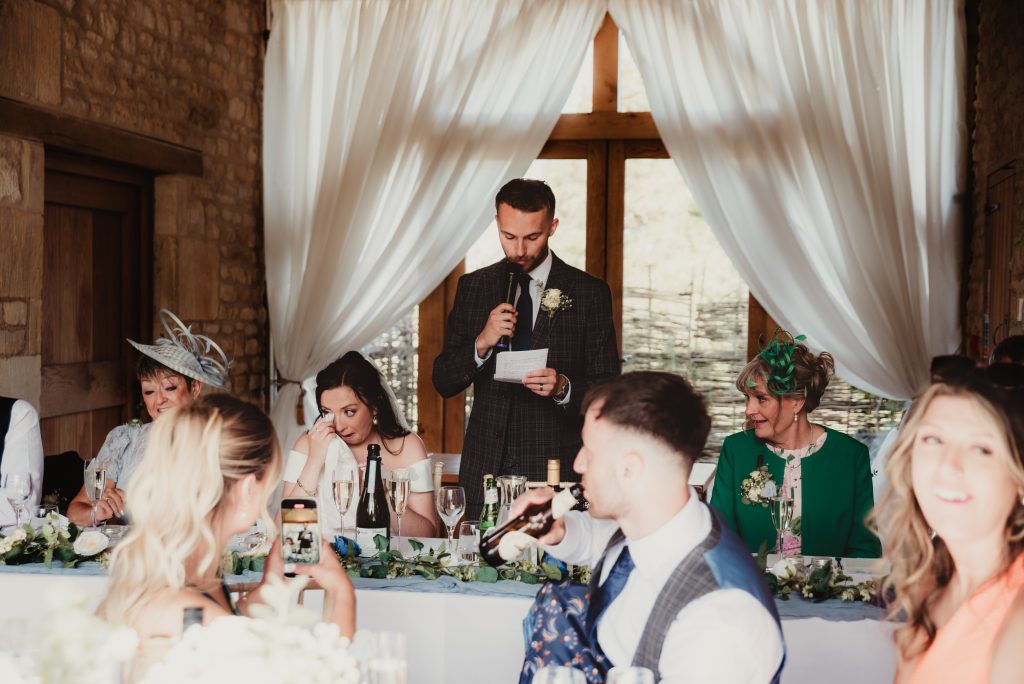 Grom delivering an emotional speech, captured by documentary-style Gloucestershire wedding photographer