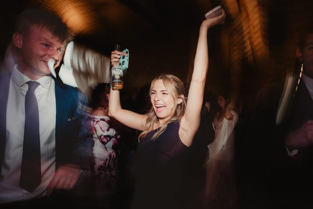 High-energy dancefloor at Upcote Barn wedding reception, photographed in a candid documentary style